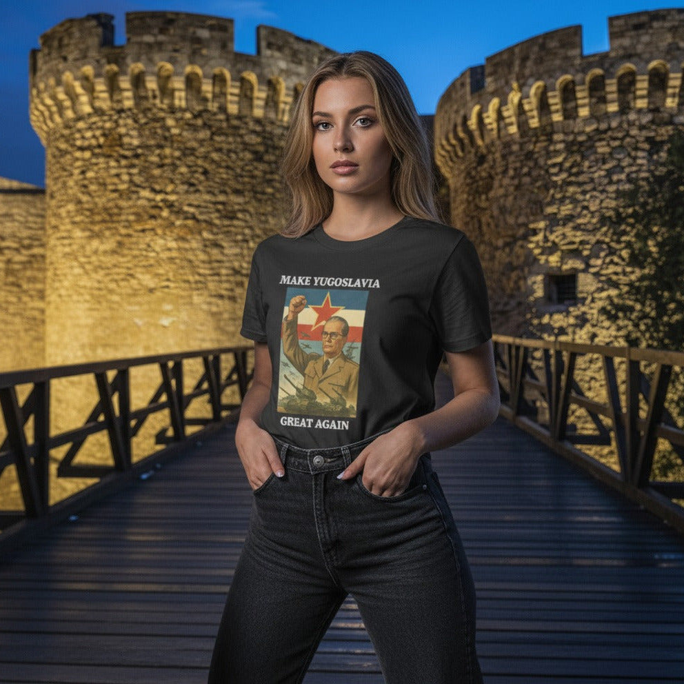 Woman wearing a t-shirt with a graphic design in front of a castle-like structure.